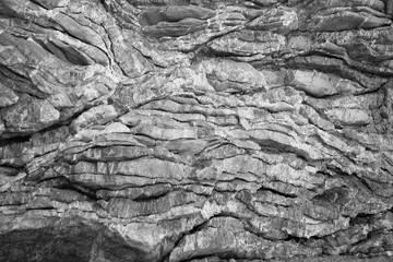 Gray background from natural limestone relief. Art irregular stone surface for publication, design,...