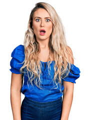 Young blonde woman wearing casual clothes afraid and shocked with surprise and amazed expression, fear and excited face.