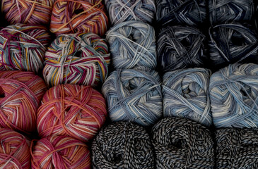 Multicolored skeins of wool for knitting as a background.