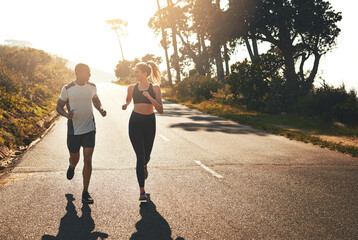 Getting the blood flowing with a workout buddy. Shot of a fit young couple going for a run outdoors.