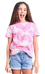Obraz premium Cute hispanic child girl wearing casual clothes winking looking at the camera with sexy expression, cheerful and happy face.