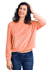 Fototapeta premium Young beautiful hispanic woman wearing casual clothes confuse and wonder about question. uncertain with doubt, thinking with hand on head. pensive concept.