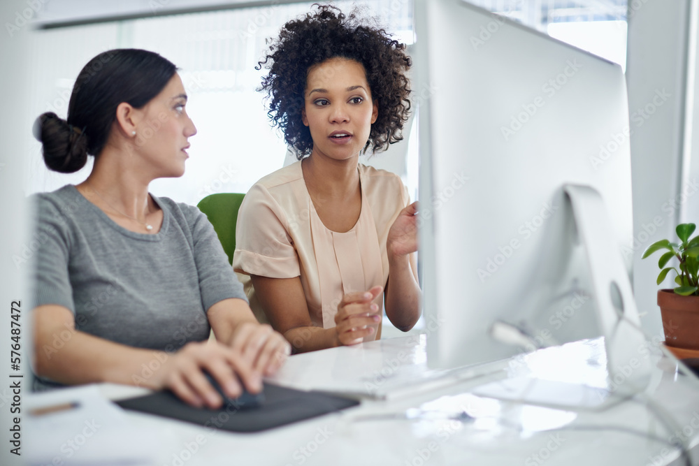 Poster she enjoys helping her colleagues where she can. shot of two creative businesspeople working togethe