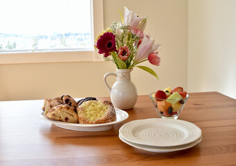Easter spring brunch breakfast with tasty pastries and bouquet of flowers
