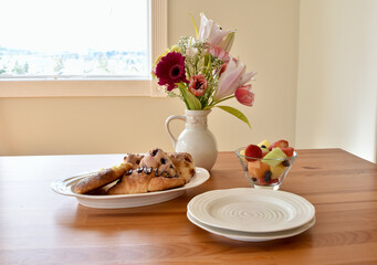 Easter spring brunch breakfast with tasty pastries and bouquet of flowers