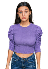 Young hispanic girl wearing casual clothes depressed and worry for distress, crying angry and afraid. sad expression.