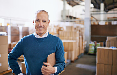 All your import and export needs. Portrait of a mature man standing in a distribution warehouse. - Powered by Adobe
