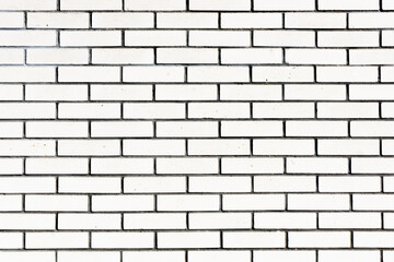 White brick wall background. Outdoor house facade texture. Gray vintage block structure. Old architecture background. Simple bright block pattern.
