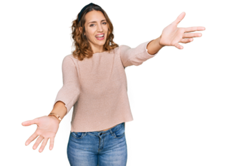 Beautiful young caucasian woman wearing casual sweater looking at the camera smiling with open arms for hug. cheerful expression embracing happiness.