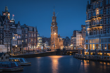 Evening panoramic view of the famous historic center with lights, bridges, canals and traditional Dutch houses in Amsterdam, Netherlands