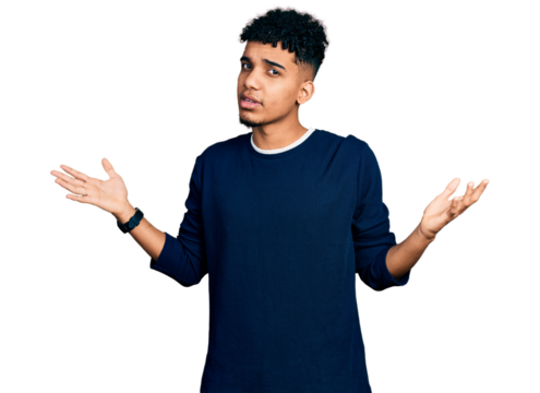 Young african american man wearing casual clothes clueless and confused with open arms, no idea concept.