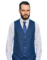 Young man with beard wearing business vest skeptic and nervous, frowning upset because of problem. negative person.