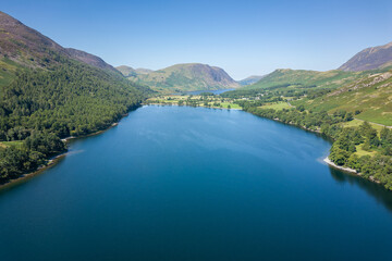 Aerial view of a beautiful lake and small beach in a rural valley (Buttermere, Lake District, England)