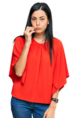 Beautiful young woman wearing casual clothes mouth and lips shut as zip with fingers. secret and...