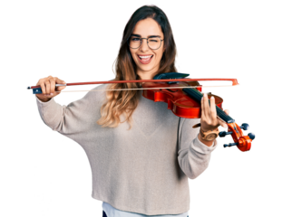 Beautiful hispanic woman playing violin winking looking at the camera with sexy expression, cheerful and happy face.