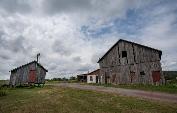 old barn in field along dirt road