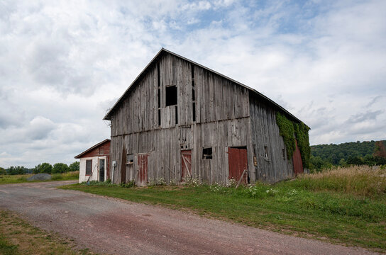 old barn in field along dirt road
