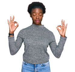 Young african american girl wearing casual clothes relax and smiling with eyes closed doing meditation gesture with fingers. yoga concept.