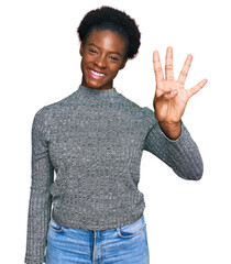 Young african american girl wearing casual clothes showing and pointing up with fingers number four while smiling confident and happy.