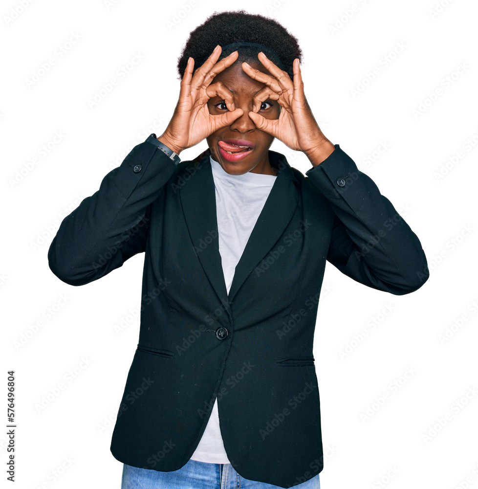 Poster Young african american girl wearing business clothes doing ok gesture like binoculars sticking tongue out, eyes looking through fingers. crazy expression.