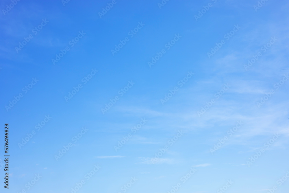 Wall mural blue sky background and white clouds soft focus, and copy space horizontal shape.