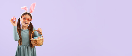 Funny girl with bunny ears and Easter basket on lilac background with space for text