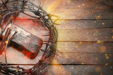 Crown of thorns, nails and cross on wooden background with space for text