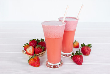 Strawberry yogurt fruit juice smoothie pink colorful fruit juice milkshake blend beverage healthy high protein the taste yummy In glass drink episode morning on white wood background.