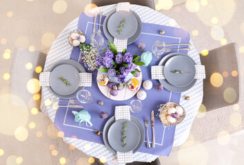 Festive table setting for Easter celebration in dining room, top view