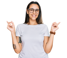 Young hispanic woman wearing casual white t shirt smiling confident pointing with fingers to different directions. copy space for advertisement