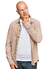 Middle age bald man wearing casual clothes with hand on chin thinking about question, pensive expression. smiling with thoughtful face. doubt concept.