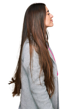 Young hispanic girl wearing business clothes looking to side, relax profile pose with natural face with confident smile.