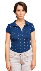 Fototapeta premium Young brunette woman with short hair wearing casual clothes depressed and worry for distress, crying angry and afraid. sad expression.