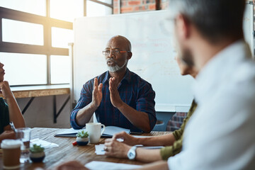 Its best to explain in detail. Cropped shot of a group of business colleagues in the office having...