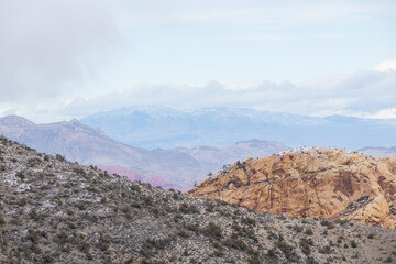 Desert landscape with mountain background and blue sky with white clouds