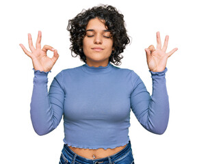Young hispanic woman with curly hair wearing casual clothes relax and smiling with eyes closed doing meditation gesture with fingers. yoga concept.