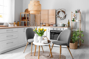 Interior of kitchen with Easter decor, white counters and table