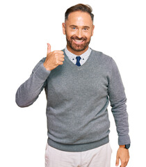 Handsome middle age man wearing business clothes doing happy thumbs up gesture with hand. approving expression looking at the camera showing success.