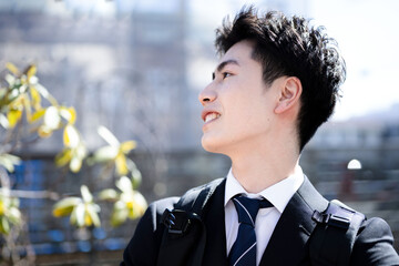 Easy to use in business Image of a new graduate or new employee Young Asian man in a suit In an office district