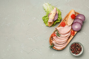 Board with ingredients for ham sandwich on grey grunge background