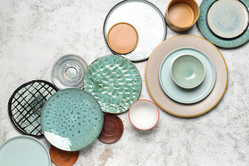 Composition with clean ceramic plates and bowls on white background