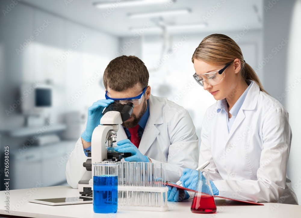 Poster young smart scientist working with microscope in the lab
