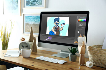 Animator's workplace. Modern computer with illustration on screen