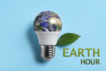 Take care of environment. Light bulb with globe, green leaf and words Earth hour on light blue...
