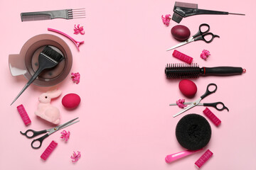 Frame made of hairdressing accessories, Easter eggs and flowers on pink background
