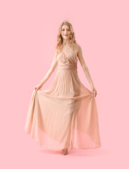 Teenage girl in crown and prom dress on pink background - obrazy, fototapety, plakaty
