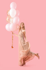 Teenage girl in prom dress with balloons on pink background © Pixel-Shot
