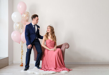 Beautiful couple dressed for prom in room