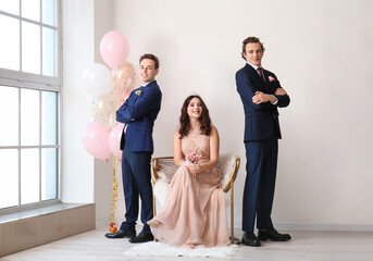 Teenage boys and girl dressed for prom in room - obrazy, fototapety, plakaty