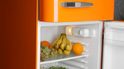 Modern open refrigerator with many different fresh fruits